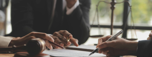 Picture of a lawyer explaining something to clients