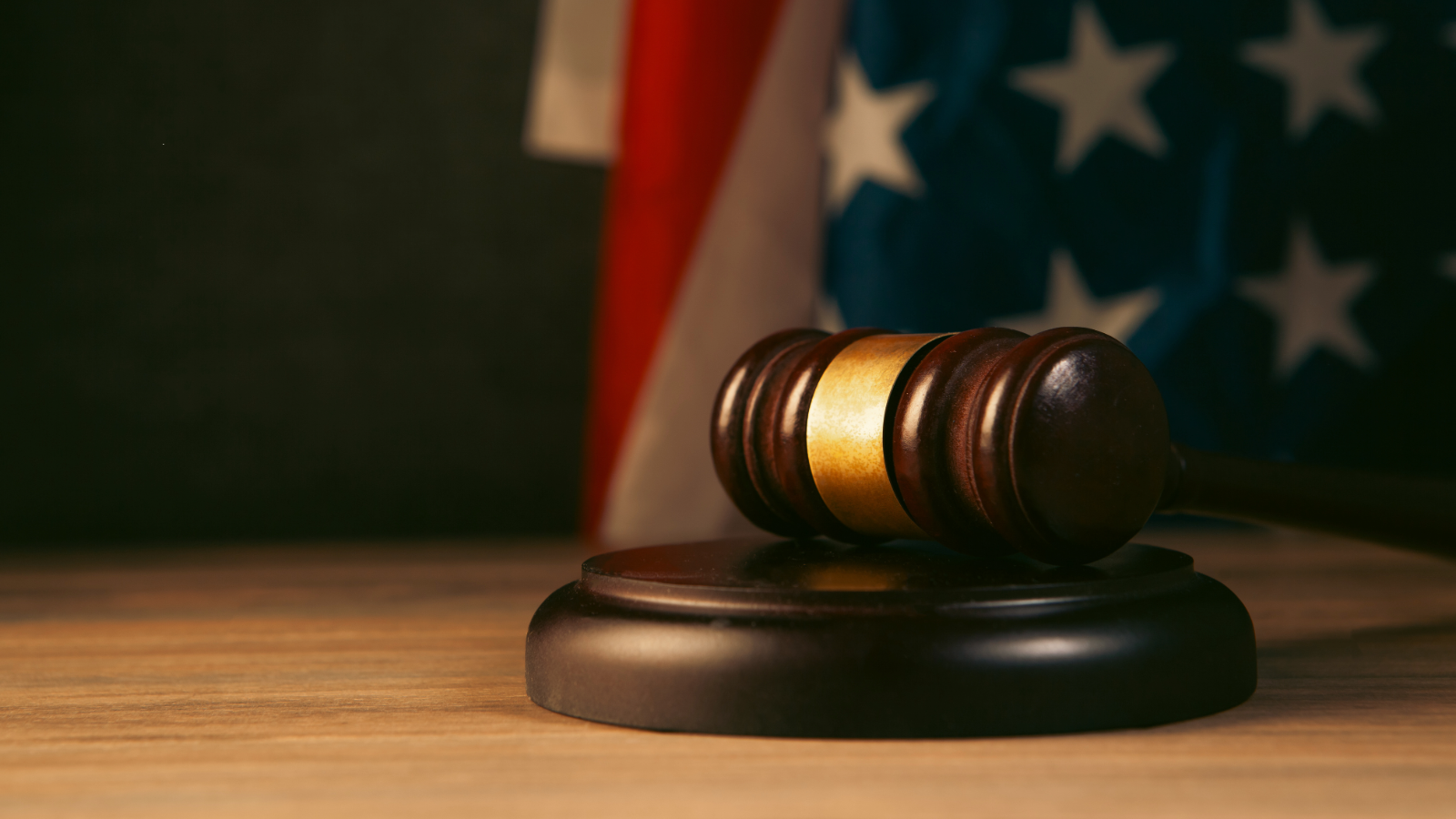 Image of a gavel and the American flag.