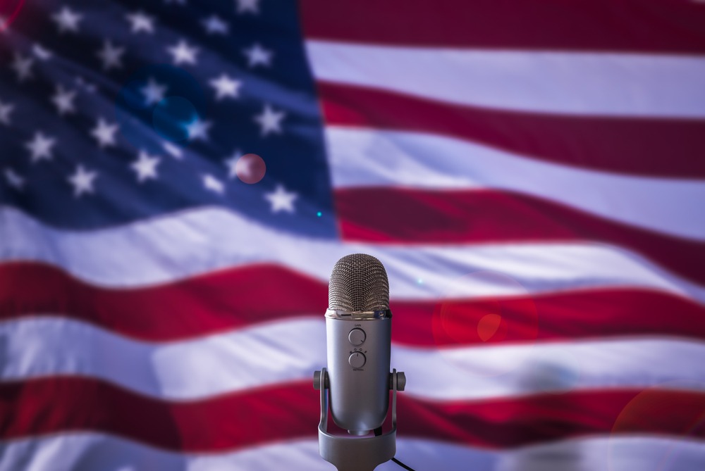 Image of an American flag and a microphone.