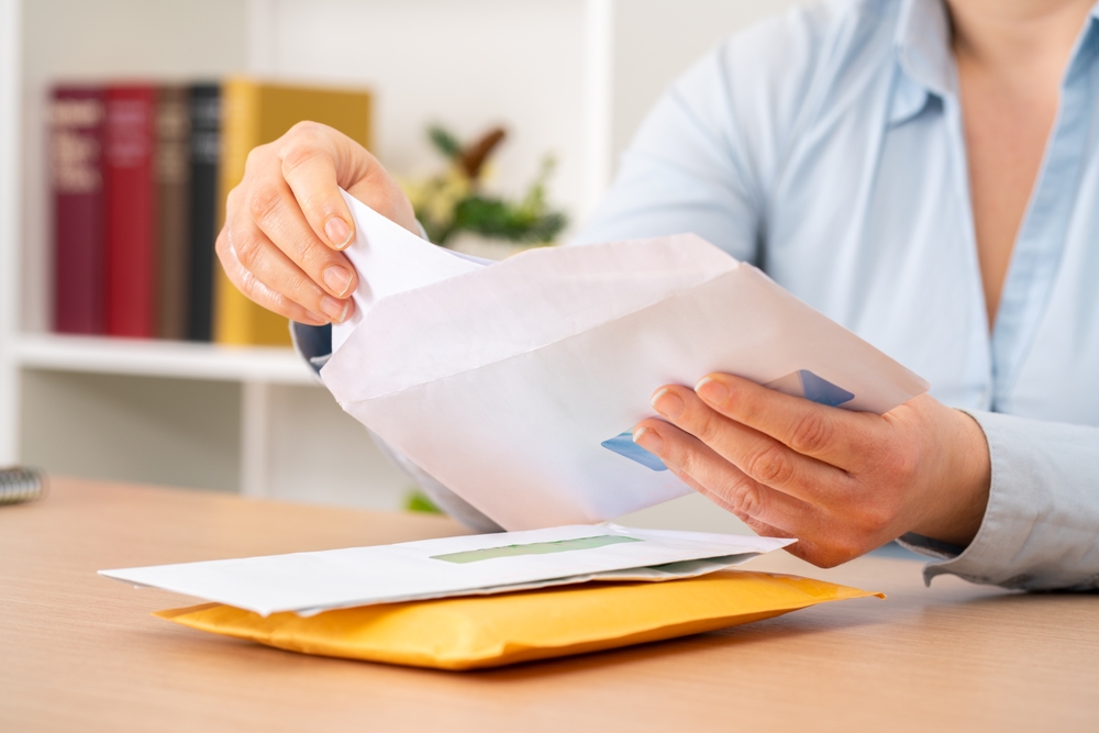 Image of an envelope being opened.